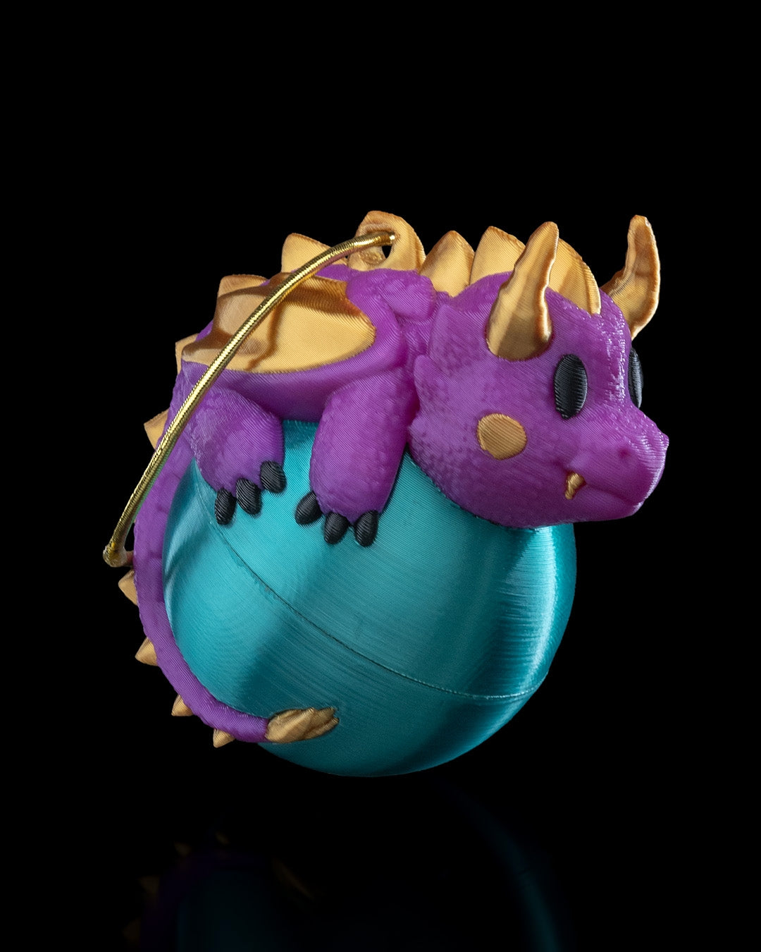 Dragonament, a dragon sleeping on an ornament